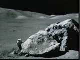 Astronaut Schmitt at base of huge boulder